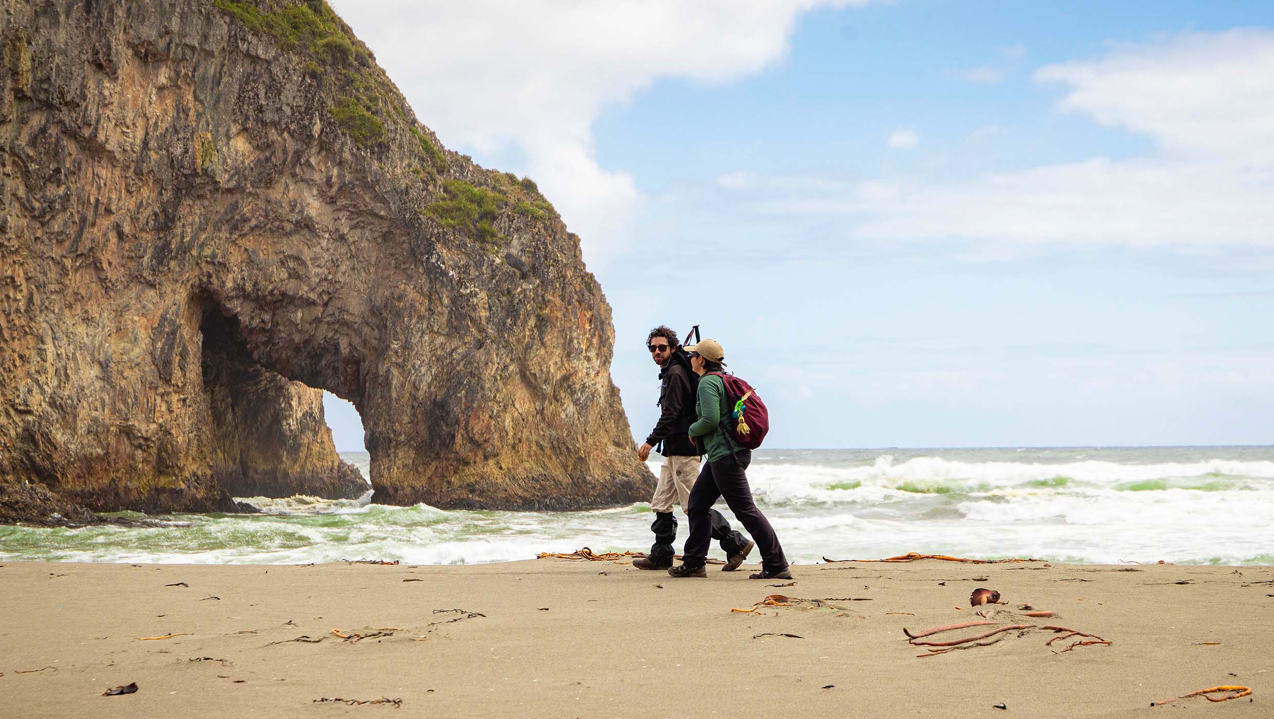 Walking on the beach as part of the Duhatao to Chepu hike, Chiloe Island, Chile